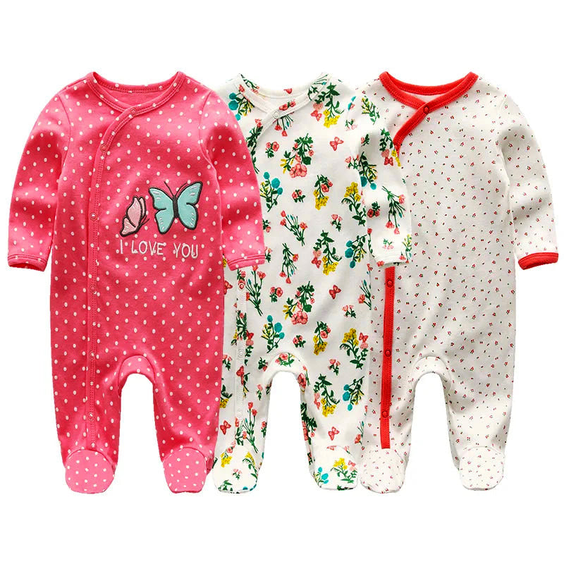 3 pack of baby organic cotton pajamas in pink, floral, and polka dot designs for 0-12 months, featuring long sleeves and footed bottoms.