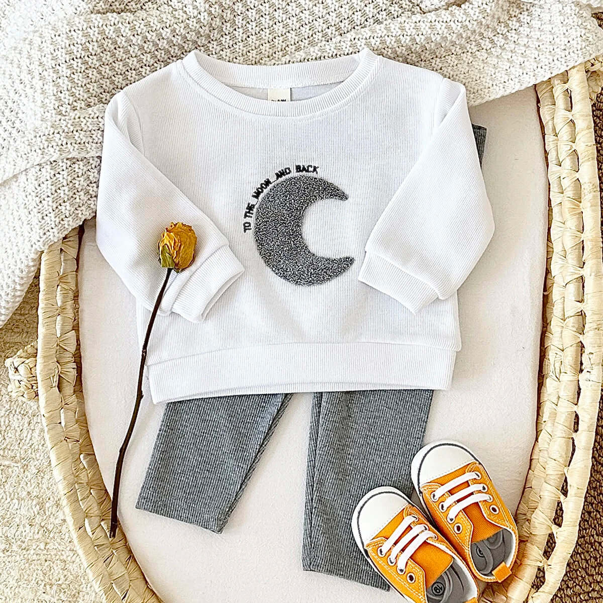 Organic cotton kids clothing set featuring sun, moon, and stars design with long sleeves and pants, suitable for ages 6M-3T.