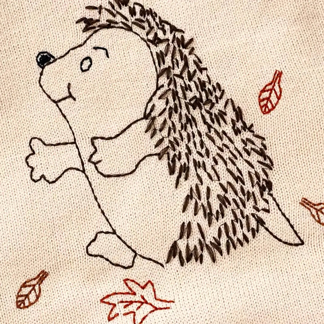 Adorable hedgehog and autumn leaves embroidery on soft knit fabric for baby romper.