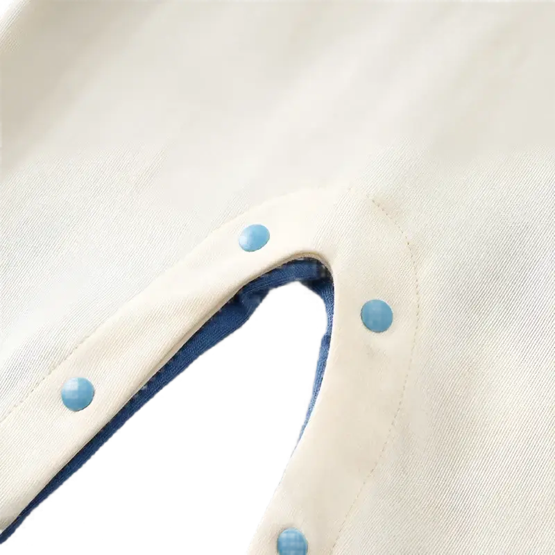 Close-up of Baby Blue Elephant Adventure Romper's snap buttons for easy diaper change, showcasing soft, breathable fabric.