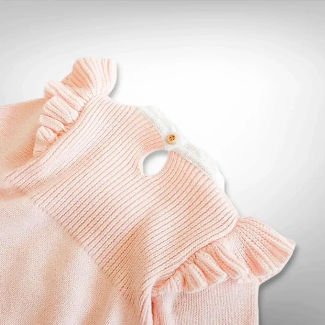 Close-up of pink Ballerina Dreams Knit Romper with ruffle accents and button closure, perfect for babies 3-24 months.