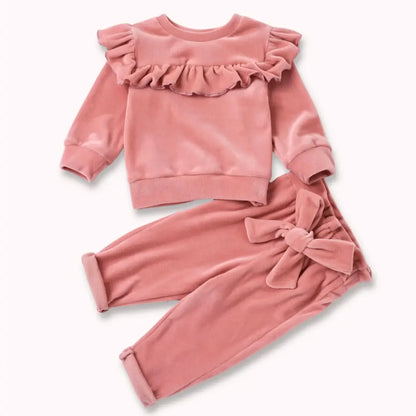 Blush ruffle velvet baby set with top and pants, featuring cozy elegance and a sweet bow, perfect for special occasions and play.