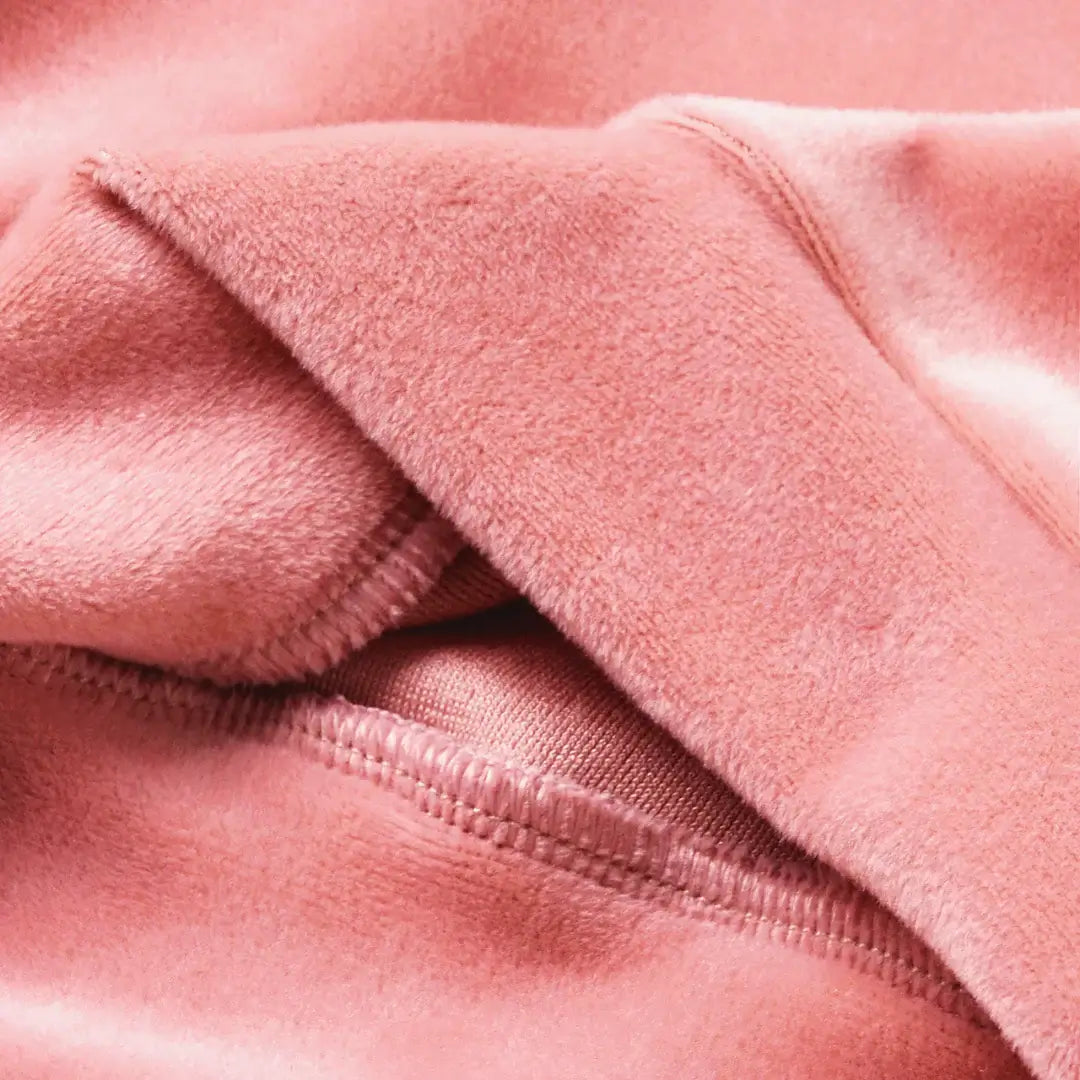 Soft blush velvet fabric detail from the Blush & Snow Ruffle Velvet Baby Set, highlighting its luxurious texture and cozy elegance.