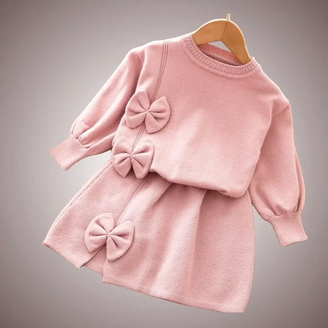 Soft pink knit set with bow accents for toddlers, cozy long sleeves and skirt, perfect for fall wardrobe elegance (18M-6Y).