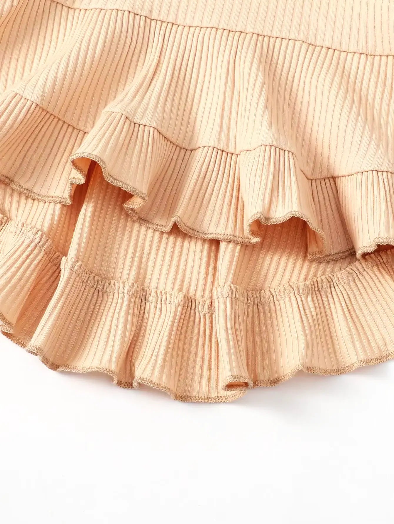 Soft beige ribbed fabric featuring playful ruffles, perfect for a stylish Boho Chic top for little ones.