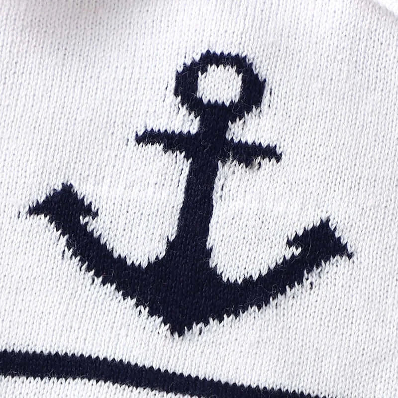 Close-up of navy anchor design on a white cotton knit romper, perfect for stylish baby sailor look.