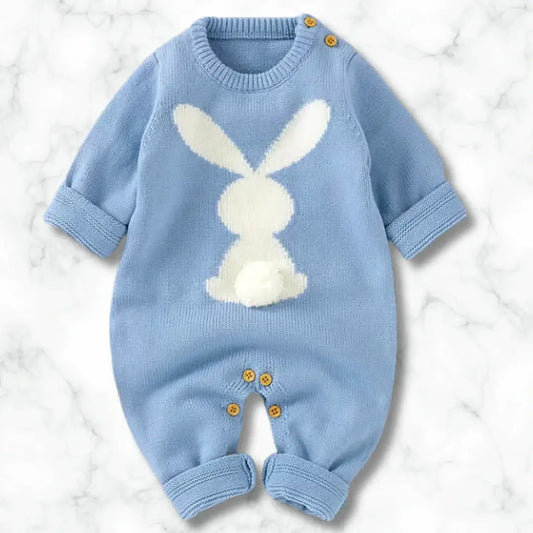 Blue knit baby romper with white bunny design and cotton tail, showcasing button accents for easy dressing.