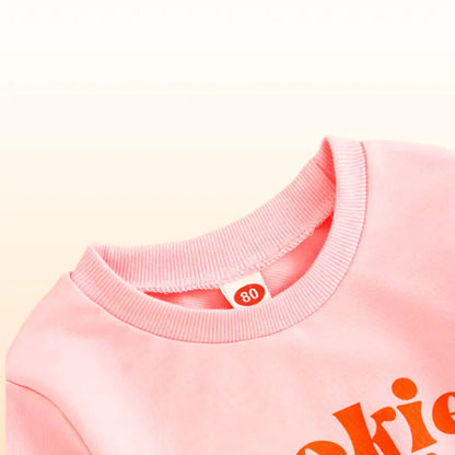 Pink Cookie Baking Crew sweatshirt with playful slogan, perfect for toddler holiday fun and style. Cozy, cute, and comfy clothing choice! 🍪