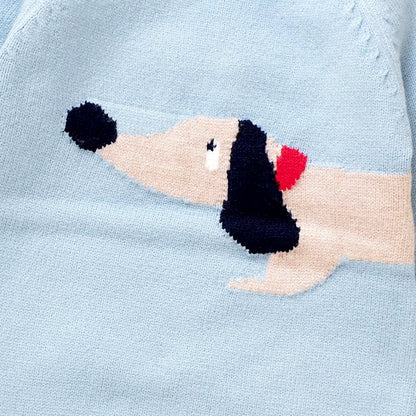 Close-up of an adorable dachshund design on a light blue knit fabric, part of the Dapper Dachshund Knit Romper for babies.