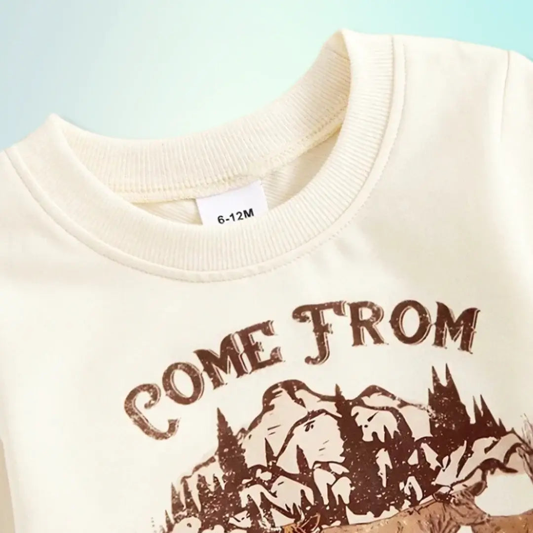 Cream sweatshirt with "Come From Good Stock" graphic featuring mountains and forest for toddlers, size 6-12M.