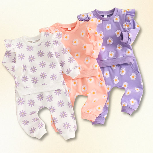 Adorable Flower Power sweatshirt and jogger sets in pastel colors for babies, featuring playful floral prints, sizes 0-18M.