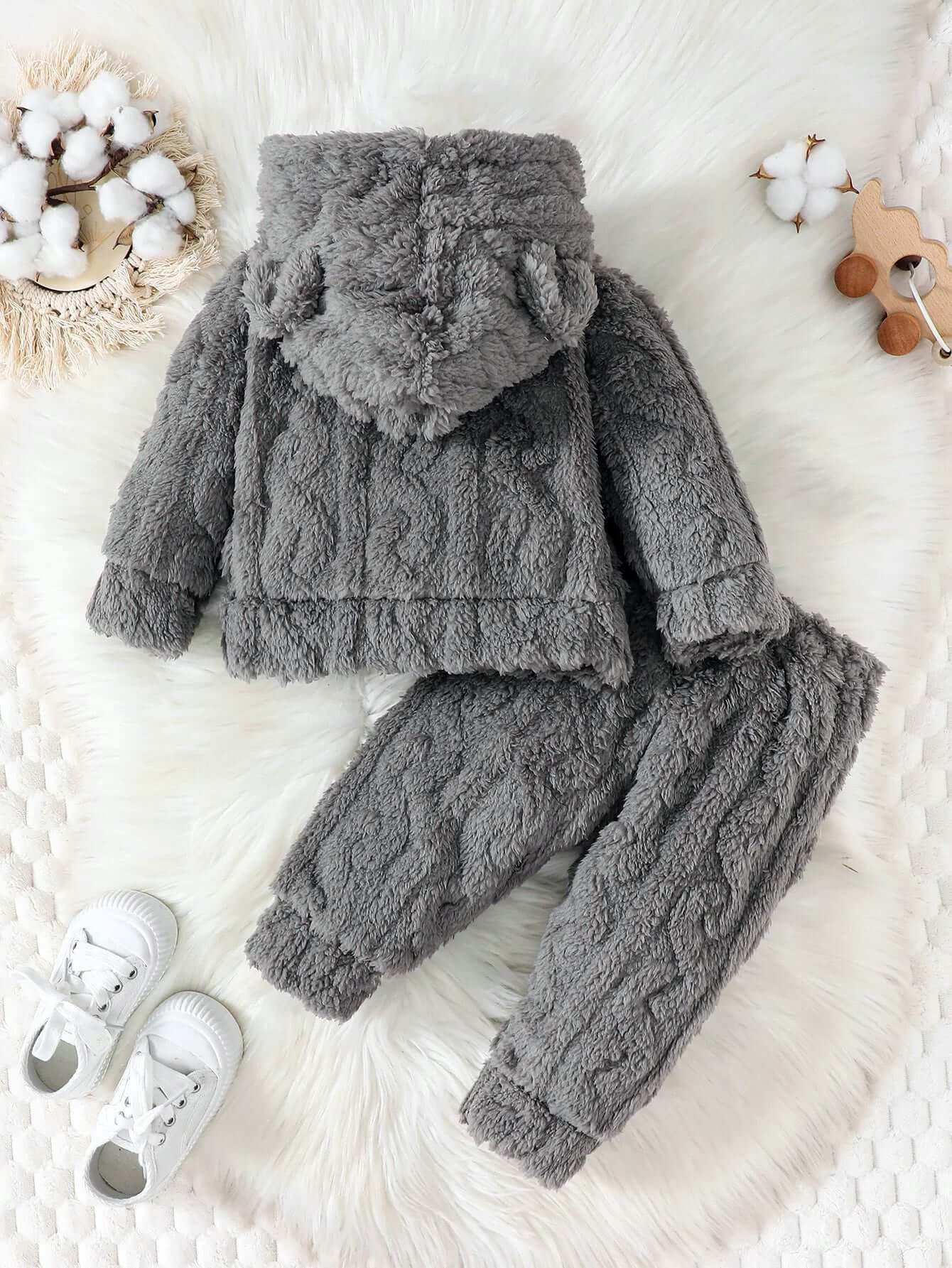 Cozy gray Cloud-Soft Knit Hoodie & Joggers Set for toddlers, laid out on a white fluffy surface with baby shoes and cotton decor.