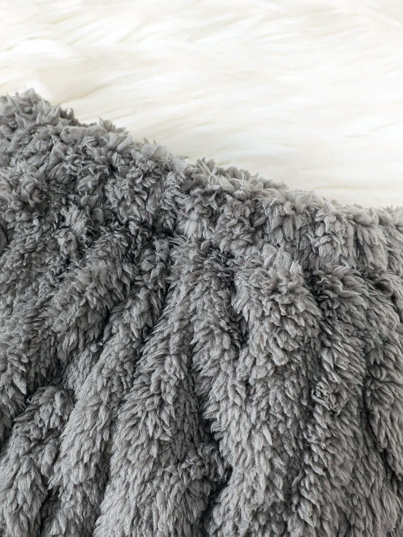 Close-up of the Cloud-Soft Knit gray fabric, showcasing its plush, fuzzy texture for a cozy hoodie and joggers set.