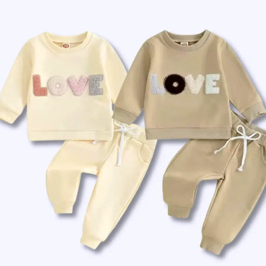 Cozy Little Love Loungewear Set featuring 'LOVE' design, soft sweatshirts, and joggers in neutral tones, perfect for babies.