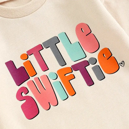 Colorful "Little Swiftie" print on baby romper, perfect for mini fans and fall fashion.