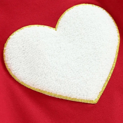 Charming heart applique on red Love & Snuggles Sweatshirt, adding a playful touch to cozy kids' clothing. Perfect for warmth and style.