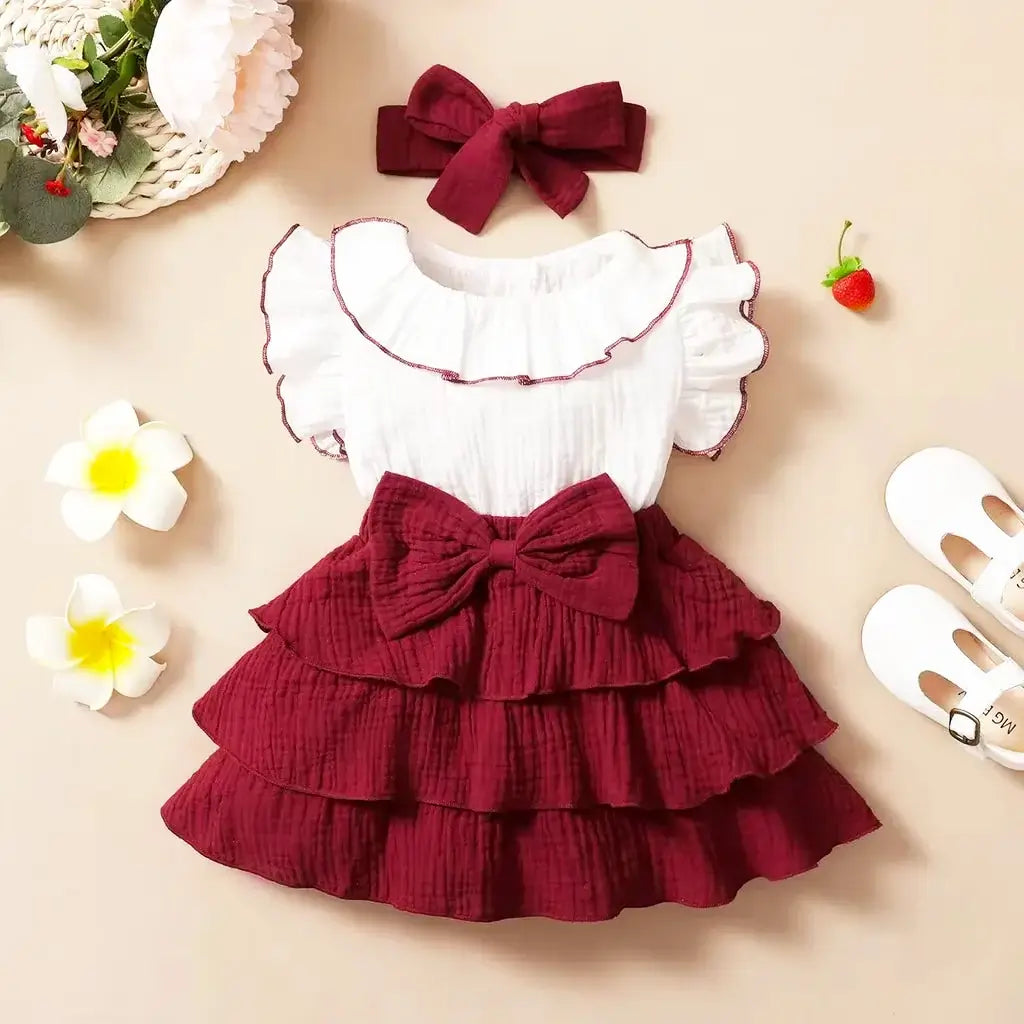 Milan Muse Butterfly Dress with burgundy ruffles and bow detail for baby girls, perfect for special occasions and family gatherings.