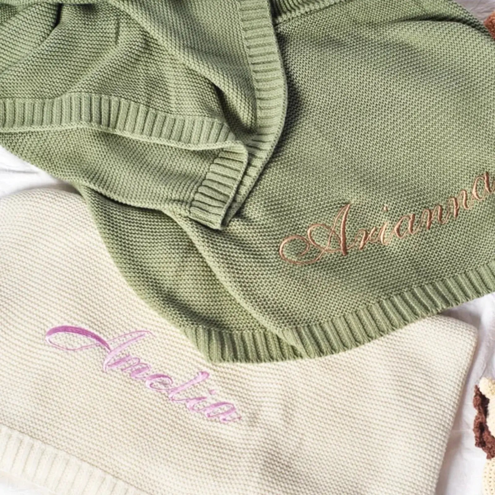 Personalized cotton baby blankets in green and cream, featuring embroidered names for a unique, cozy touch.