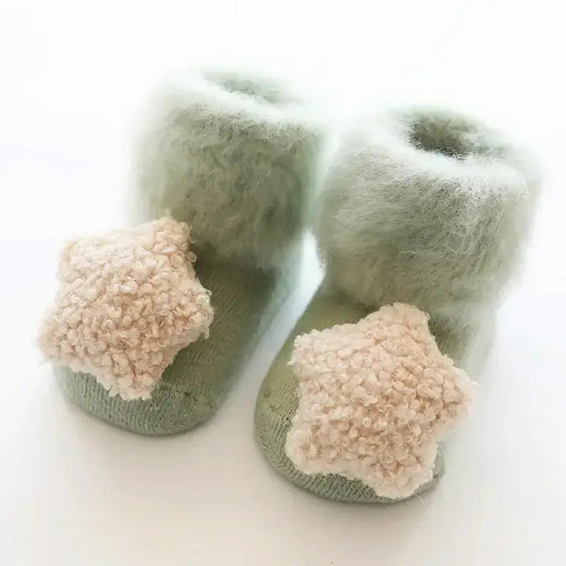 Ultra-soft pastel green baby socks with fuzzy stars, perfect for newborns and toddlers. Snuggly and anti-slip for tiny feet.