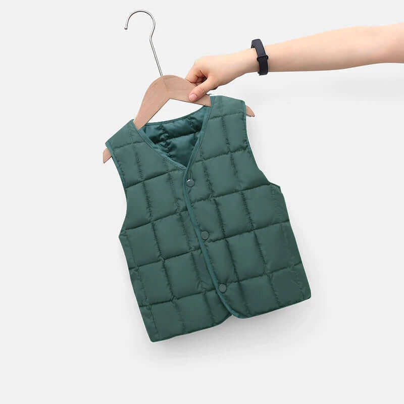 Child's green puffy vest on a hanger, perfect for toddlers aged 1-8, offering cozy warmth and style for any autumn adventure.