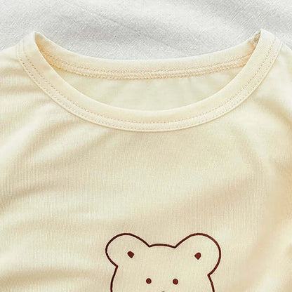 Snuggle Bear Pajamas soft stretchy top with playful bear print for babies and toddlers on a cozy background