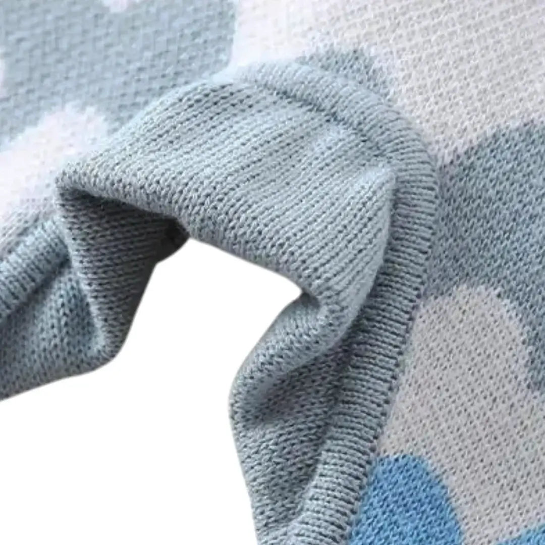 Close-up of the Sky Waves Knit Romper fabric detail in soft blue, white, and grey with a cozy knit texture.