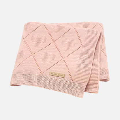 Super soft knit baby blanket in pink with heart pattern, ideal for newborns and toddlers.