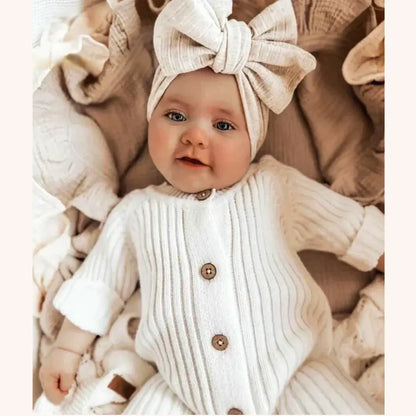 Adorable baby in a Sweet Dreams knitted cotton jumpsuit, ultra-soft and cozy, perfect for comfort and cuteness, 3-24M sizes.