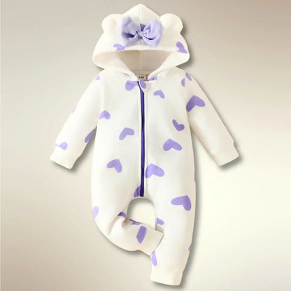 Sweetheart Snuggle Romper with heart print, bear ears, and bow hood for babies Newborn to 18M. Cozy, cute, easy zip-front design.