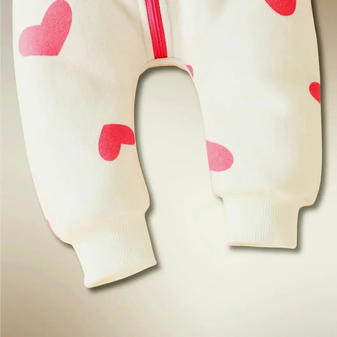 Cozy heart print on baby romper with zip-up front and soft cuffs for comfort and style.