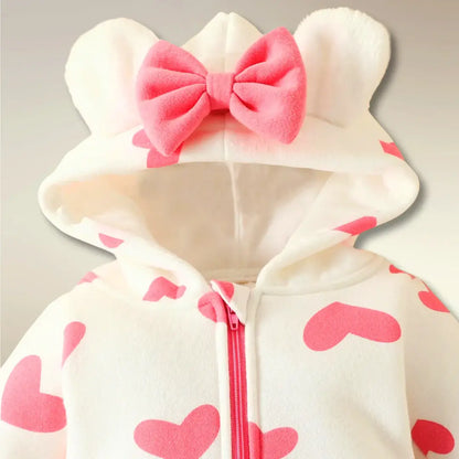 Heart print hooded romper with bear ears and bow, perfect for newborns to 18M. Cozy and cute baby outfit with easy zip-front design.