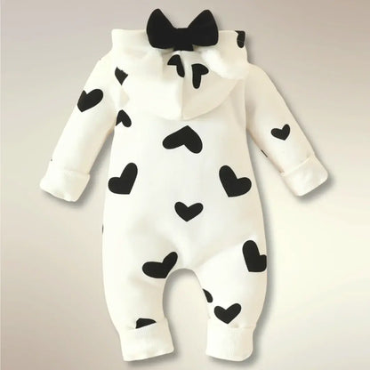 Heart print romper with hood featuring bear ears and bow, perfect for newborns. Cozy and cute snuggle design for babies.