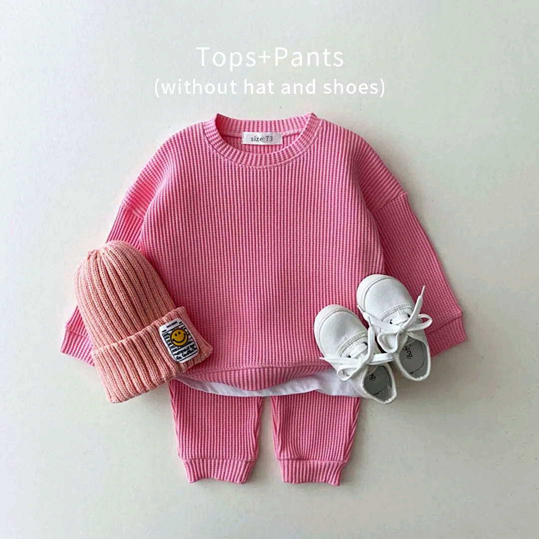 Trendy pink cotton waffle sweatshirt and matching pants set for toddlers, featuring a mock undershirt style.