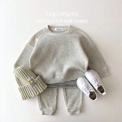 Cozy toddler waffle-knit sweatshirt and matching pants set, perfect for stylish playtime adventures.