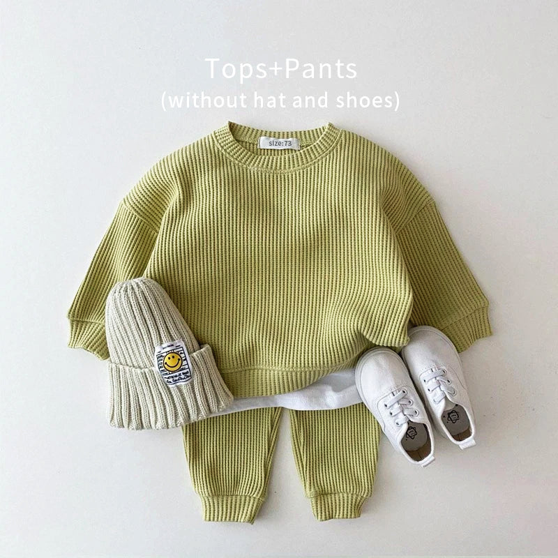 Trendy toddler cotton-waffle sweatshirt and pants set in light green for a playful, chic look. Perfect for active play!