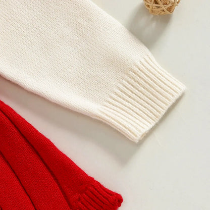 Close-up of festive knit romper cuffs in vibrant red and white, perfect for baby holiday wardrobe, 0-18M.