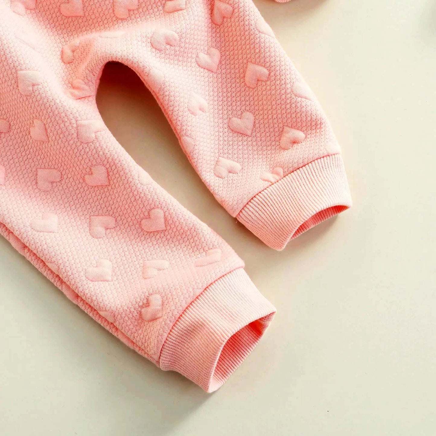 Charming heart-printed pink pants for babies with cozy fabric and chic design.