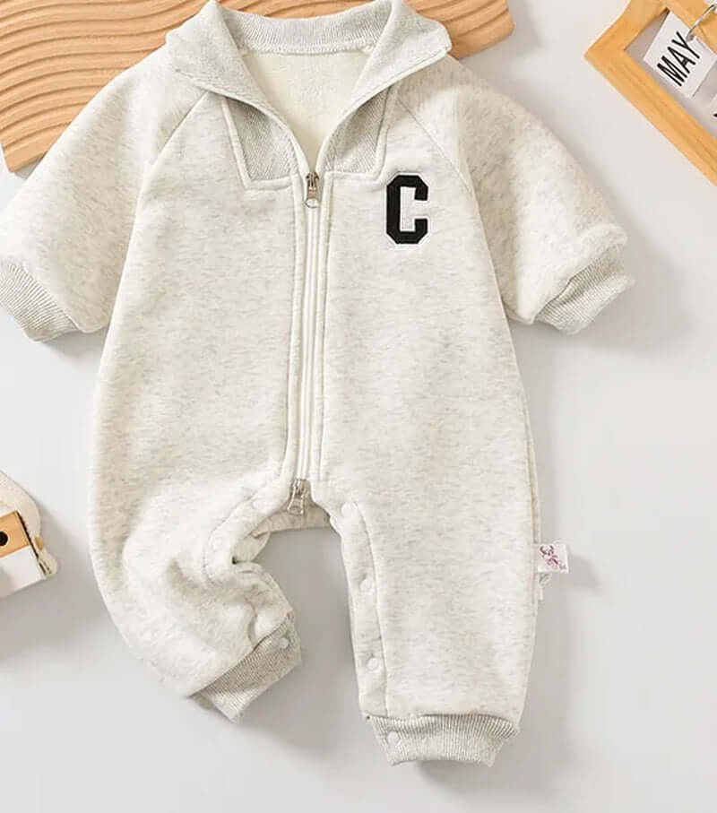 Cozy cotton sweatshirt romper for babies with collegiate embroidered lettering, ideal for autumn warmth.